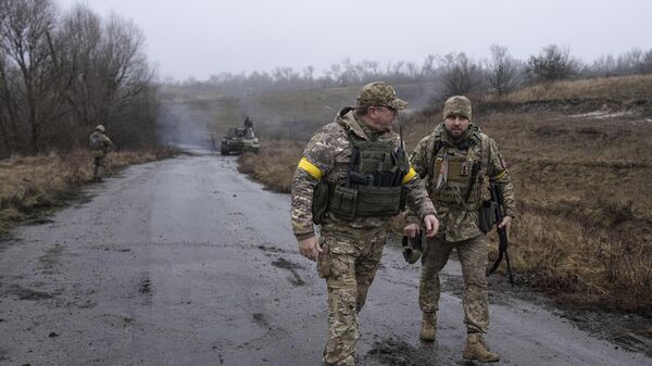 A Ukrainian brigade commander Dyadya Roma speaks to his comrade at a frontline in the Kharkov region, Ukraine, Saturday, Dec. 24, 2022 - Sputnik भारत