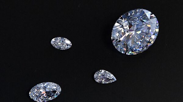 A view of the main 51.38-carat round-cut diamond, the Dynasty, among other gems from Russian diamond miner Alrosa’s Dynasty polished diamonds collection in Moscow on August 3, 2017. The collection of five polished stones was manufactured from a 179-carat Romanovs rough diamond, extracted at the company’s Nyurbinskaya kimberlite pipe in Russia's far northeast region of Yakutia in 2015. Alrosa plans to sell the whole collection in one set at a special online auction in November with the starting price not less than $10 million, according to the company’s CEO Ivanov. (Photo by Yuri KADOBNOV / AFP) - Sputnik भारत