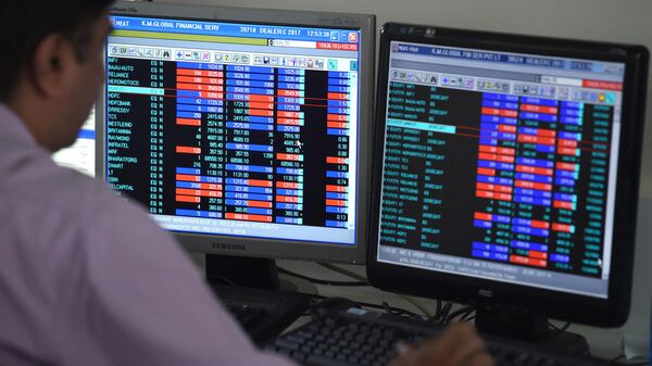 An Indian stock dealer trades shares during intra-day trade at a brokerage house in Mumbai on December 18, 2017. (Photo by INDRANIL MUKHERJEE / AFP) - Sputnik India