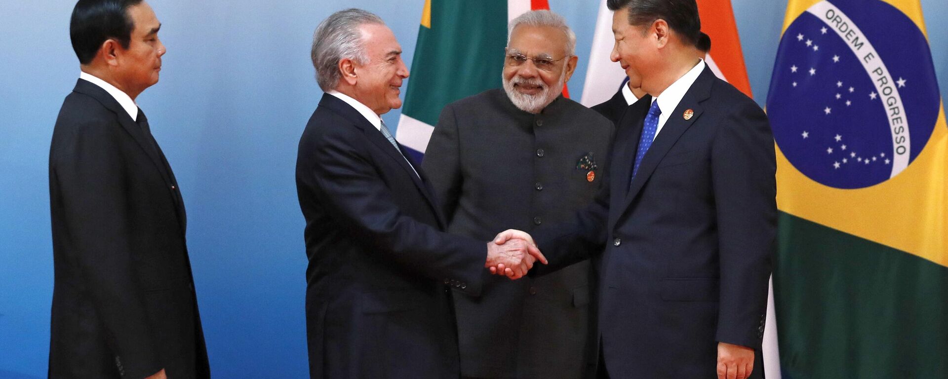 Chinese President Xi Jinping, right, greets Thai Prime Minister Prayuth Chan-ocha, left, Brazilian President Michel Temer, second from left, and Indian Prime Minister Narendra Modi before a group photo of the Emerging Market and Developing Countries meeting at the BRICS Summit, in Xiamen, China, Tuesday, Sept. 5, 2017.  - Sputnik भारत, 1920, 01.07.2024