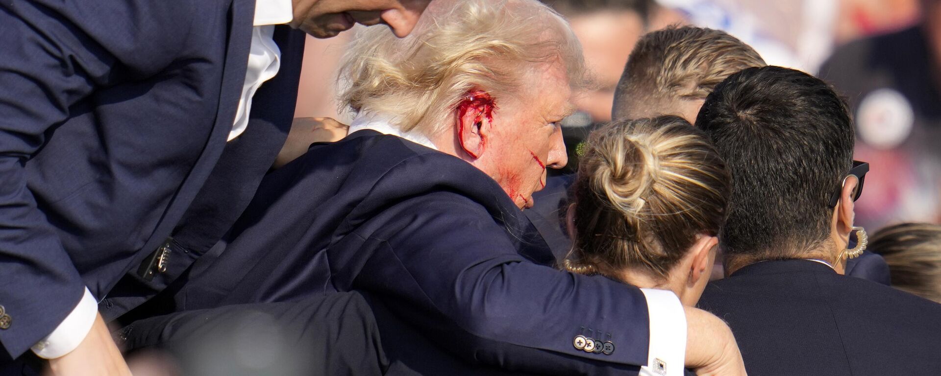 Republican presidential candidate former President Donald Trump is helped off the stage at a campaign event in Butler, Pa., on Saturday, July 13, 2024.  - Sputnik India, 1920, 14.07.2024