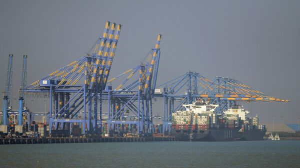 This photo taken on December 21, 2016 shows a container ship (R) docked at India's Adani Port Special Economic Zone (APSEZ) in Mundra - Sputnik India