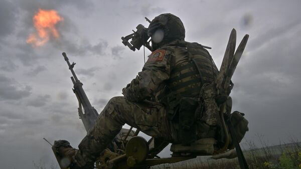 A Russian serviceman  fires a NSV Utyos heavy machine gun at an air target amid Russia's military operation in Ukraine - Sputnik India