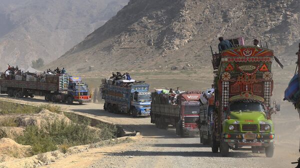 A convey of trucks carrying Afghan families drive toward a border crossing point in Torkham, Pakistan, Tuesday, Oct. 31, 2023.  - Sputnik India