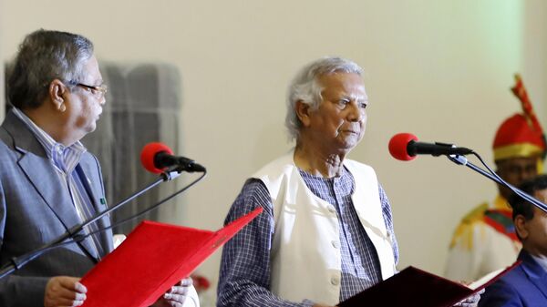 Bangladesh's figurehead President Mohammed Shahabuddin administers the oath of office to Nobel laureate Muhammad Yunus, right, as the head of Bangladesh's interim government, in Dhaka, Bangladesh, Thursday, Aug. 8, 2024. (AP Photo/Rajib Dhar) - Sputnik India