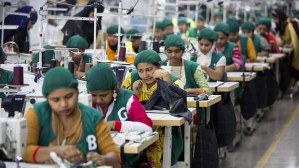 FILE - In this April 19, 2018 file photo, trainees work at Snowtex garment factory in Dhamrai, near Dhaka, Bangladesh. Bangladesh is gradually reopening its hundreds of garment factories after nearly one month of closure following a government decision for a nationwide lockdown amid concern that coronavirus could spread widely among the industry’s millions of workers, an industry leader said Tuesday.  (AP Photo/A.M. Ahad, File) - Sputnik India