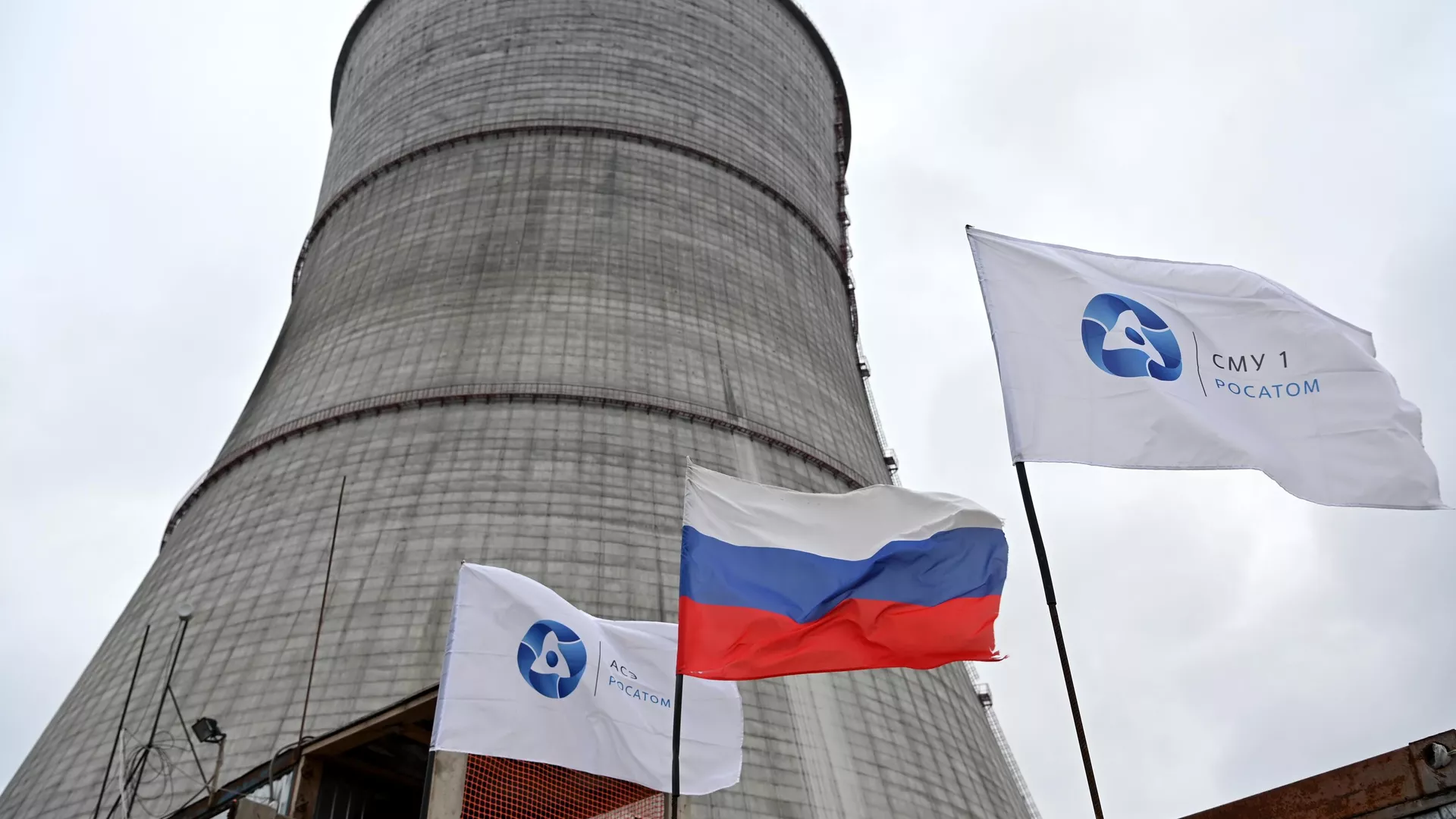 A Russian national flag and flags with the logo of Rosatom flutters at the construction site of a cooling tower at the Kursk II nuclear power plant near the village of Makarovka outside Kurchatov, Kursk region, Russia