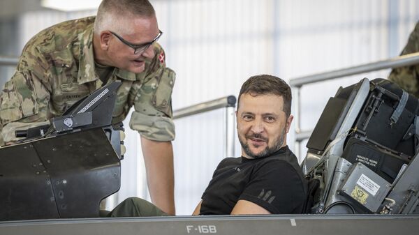 Volodymyr Zelensky sits in a F-16 fighter jet in the hangar of the Skrydstrup Airbase in Vojens, northern Denmark, - Sputnik India