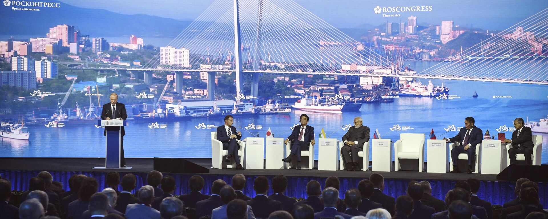 Russian President Vladimir Putin, left, delivers a speech as, from 2nd left, a moderator Sergei Brilev, Japanese Prime Minister Sinzo Abe, Russian President Vladimir Putin, India's Prime Minister Narendra Modi, Mongolia's President Khaltmaagiin Battulga and Prime Minister of Malaysia Mahathir Mohamad attend a plenary session of the Eastern Economic Forum in Vladivostok, Russia, Thursday, Sept. 5, 2019. Vladivostok hosts the Eastern Economic Forum on September 4-6. - Sputnik भारत, 1920, 26.08.2024