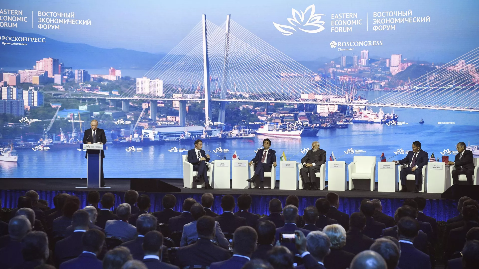 Russian President Vladimir Putin, left, delivers a speech as, from 2nd left, a moderator Sergei Brilev, Japanese Prime Minister Sinzo Abe, Russian President Vladimir Putin, India's Prime Minister Narendra Modi, Mongolia's President Khaltmaagiin Battulga and Prime Minister of Malaysia Mahathir Mohamad attend a plenary session of the Eastern Economic Forum in Vladivostok, Russia, Thursday, Sept. 5, 2019. Vladivostok hosts the Eastern Economic Forum on September 4-6.