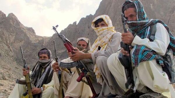 Baloch fighters from the Balochistan Liberation Army crouch at an undisclosed location along the Afghan-Pakistan border. There are several Baloch insurgent groups fighting for independence in Pakistan. Some of their fighters often cross the border to evac - Sputnik India