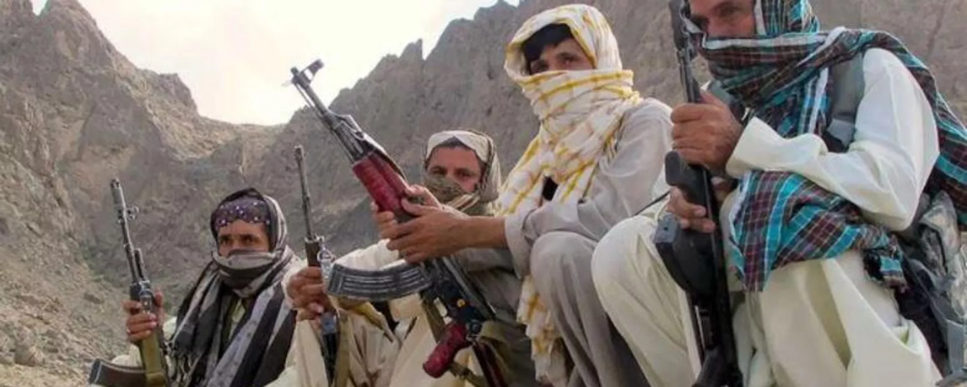 Baloch fighters from the Balochistan Liberation Army crouch at an undisclosed location along the Afghan-Pakistan border. There are several Baloch insurgent groups fighting for independence in Pakistan. Some of their fighters often cross the border to evac - Sputnik India, 1920, 21.03.2025