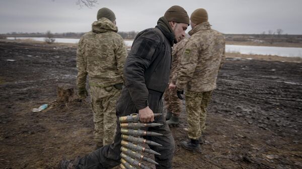A Ukrainian serviceman carries large caliber ammunitions for armored fighting vehicles mounted weapons in the Donetsk region, Thursday, Feb. 10, 2022 - Sputnik India