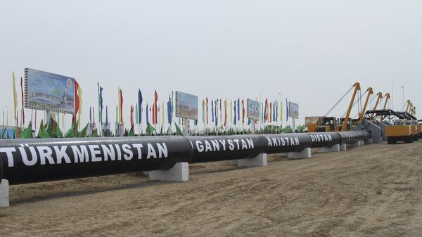 In this Feb. 23, 2018 photo, workers at the Turkmen-Afghan border prepare to weld the first link crossing the frontier during the integration ceremony of the pipeline in Serhetabat, Turkmenistan. The 1840-kilometer (1140-mile) TAPI pipeline is to carry 33 billion cubic meters of gas a year, an important new export outlet for Turkmenistan whose economy centers on its vast natural gas reserves. (AP Photo/Alexander Vershinin) - Sputnik India