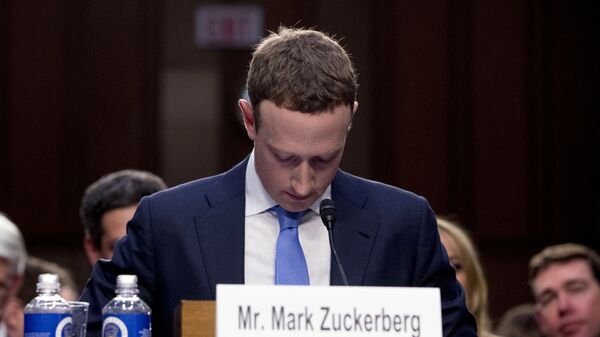 In this April 10, 2018, file photo Facebook CEO Mark Zuckerberg looks down as a break is called during his testimony before a joint hearing of the Commerce and Judiciary Committees on Capitol Hill in Washington. - Sputnik India