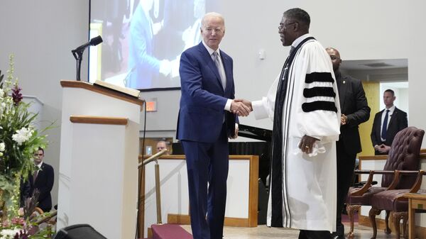 Reverend Dr. Jamey O. Graham, Sr. right, greets President Joe Biden before Biden speaks at St. John Baptist Church, in Columbia, S.C., on Sunday, Jan. 28, 2024. (AP Photo/Jacquelyn Martin) - Sputnik India