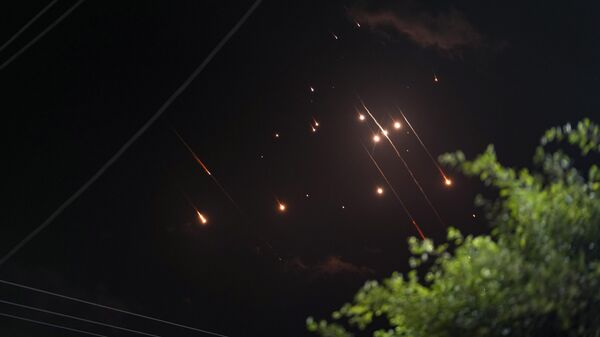 Missiles launched from Iran towards Israel streak across the night sky as seen from Deir al-Balah, Gaza Strip, Tuesday, Oct. 1, 2024 - Sputnik भारत