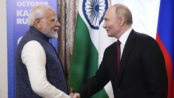 Russian President Vladimir Putin, right, and Indian Prime Minister Narendra Modi shake hands during their meeting on the sidelines of BRICS Summit at Kazan Kremlin in Kazan, Russia, Tuesday, Oct. 22, 2024. (AP Photo/Alexander Zemlianichenko, Pool) - Sputnik India