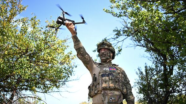 A Russian serviceman with a drone in the special operation zone. File photo - Sputnik India