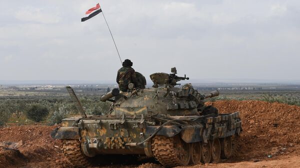 A soldier of the Syrian army guards atop of a military tank in a forward position, outside Aleppo, Syria. - Sputnik India