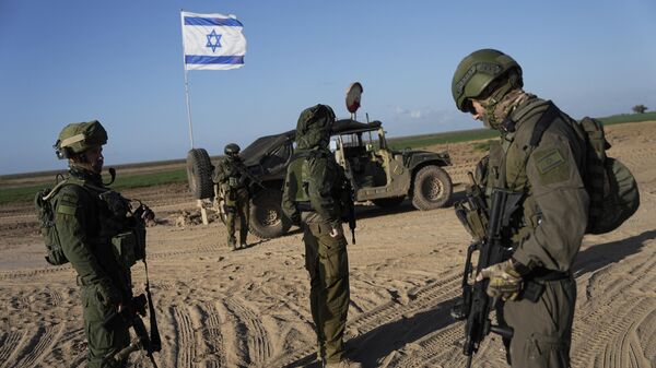 Israeli soldiers are seen near the Gaza Strip border in southern Israel, Monday, March 4, 2024 - Sputnik India