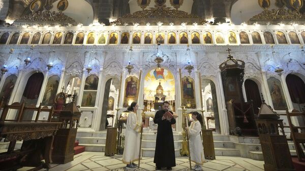 A Syrian priest attends the first Sunday Mass since Syrian President Bashar Assad's ouster, at Mariamiya Orthodox Church in old Damascus, Syria, Sunday, Dec. 15, 2024. - Sputnik India