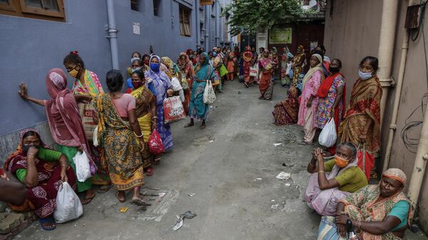 Impoverished people wait outside the Missionaries of Charity, the order founded by Saint Teresa, to receive food distributed on the anniversary of the saint's death in Kolkata, India, Sunday, Sept. 5, 2021. The Nobel Peace Prize winning Catholic nun who spent 45-years serving for the poor, sick, orphaned, and dying, died in Kolkata on this day in 1997 at age 87. (AP Photo/Bikas Das) - Sputnik India