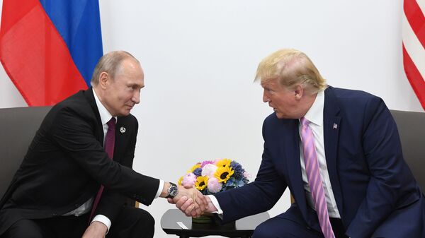 Russian President Vladimir Putin and U.S. President Donald Trump shake hands during a bilateral meeting at the at the Group of 20 (G20) leaders summit in Osaka, Japan. - Sputnik भारत