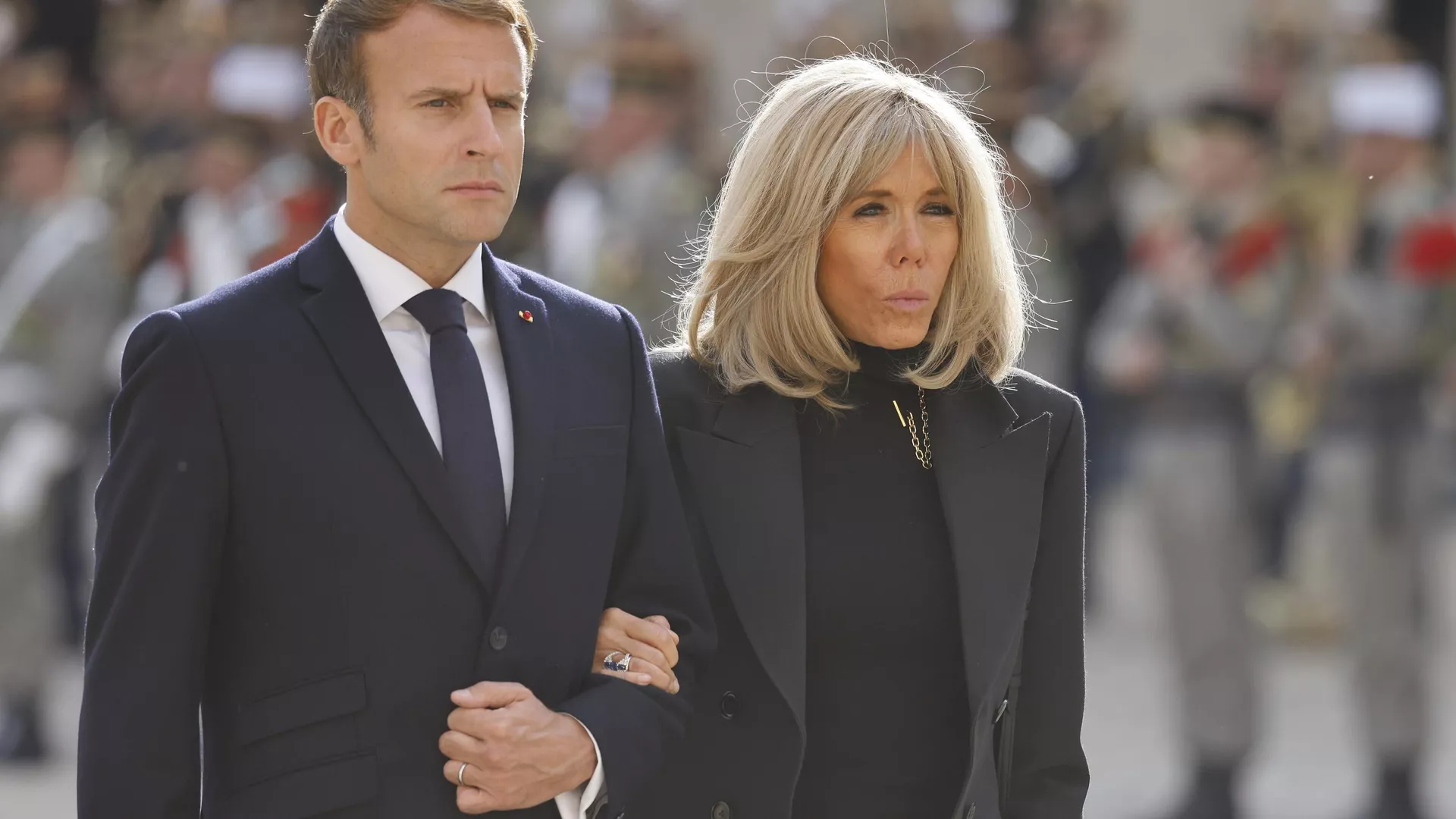 FILE. French President Emmanuel Macron and his wife Brigitte Macron attend a national memorial ceremony for Hubert Germain at the Hotel des Invalides, Friday Oct.15, 2021 in Paris. A group of atypical journalists, on the autism spectrum, got France's 45-year-old president to talk about himself with unusual and illuminating candour in a televised interview this weekend. (Ludovic Marin, Pool Photo via AP)