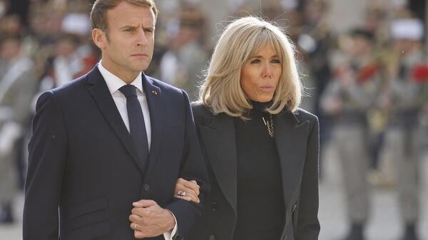 FILE. French President Emmanuel Macron and his wife Brigitte Macron attend a national memorial ceremony for Hubert Germain at the Hotel des Invalides, Friday Oct.15, 2021 in Paris. A group of atypical journalists, on the autism spectrum, got France's 45-year-old president to talk about himself with unusual and illuminating candour in a televised interview this weekend. (Ludovic Marin, Pool Photo via AP) - Sputnik India