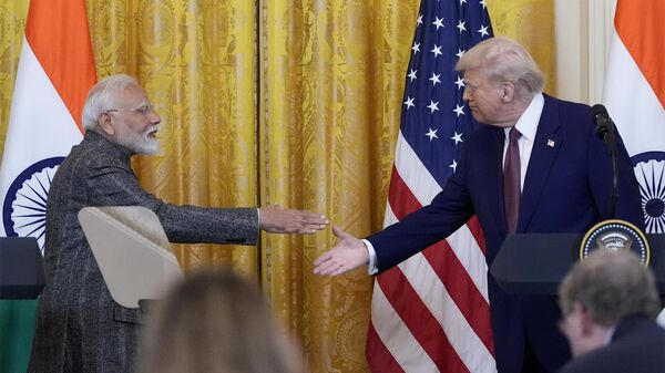 President Donald Trump and India's Prime Minister Narendra Modi shake hands during a news conference in the East Room of the White House, Thursday, Feb. 13, 2025, in Washington. (Photo/Alex Brandon) - Sputnik India