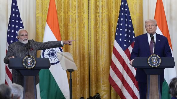 India's Prime Minister Narendra Modi points to President Donald Trump during a news conference in the East Room of the White House, Thursday, Feb. 13, 2025, in Washington. (Photo/Alex Brandon) - Sputnik India