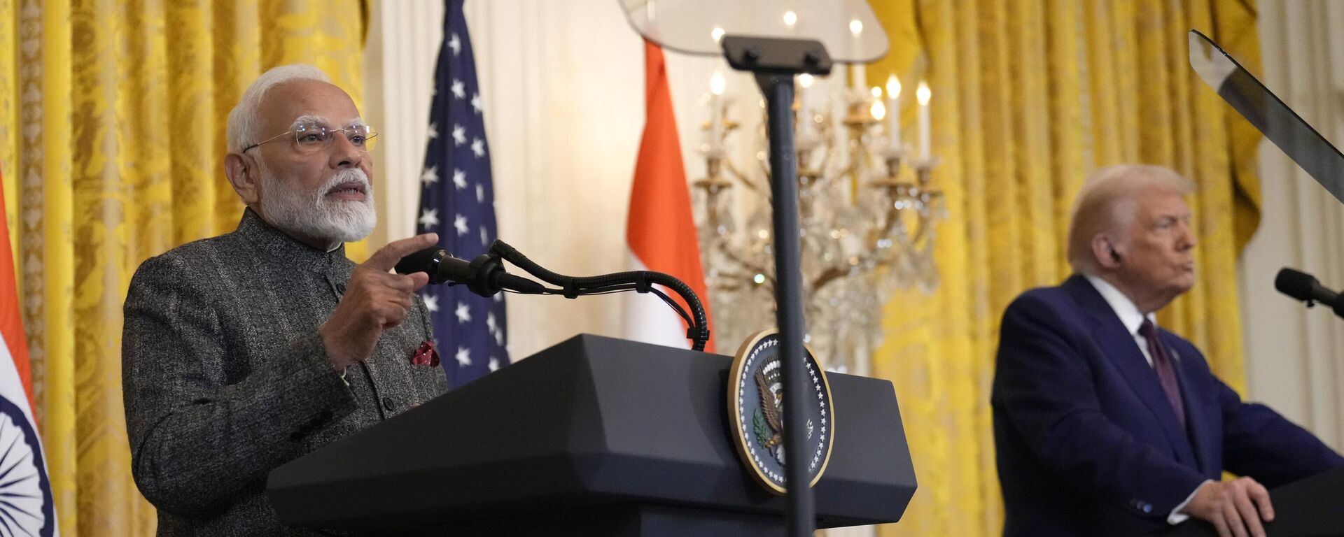 India's Prime Minister Narendra Modi speaks as President Donald Trump listens during a news conference in the East Room of the White House, Thursday, Feb. 13, 2025, in Washington. (AP Photo/Ben Curtis) - Sputnik India, 1920, 19.02.2025