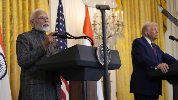 India's Prime Minister Narendra Modi speaks as President Donald Trump listens during a news conference in the East Room of the White House, Thursday, Feb. 13, 2025, in Washington. (AP Photo/Ben Curtis) - Sputnik India