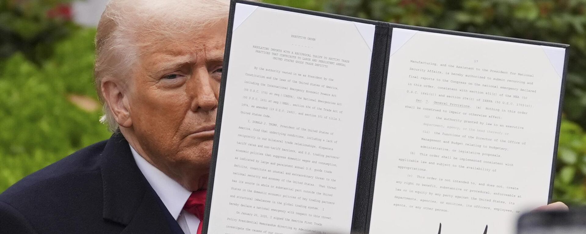 President Donald Trump holds a signed executive order during an event to announce new tariffs in the Rose Garden of the White House, Wednesday, April 2, 2025, in Washington - Sputnik India, 1920, 29.05.2025