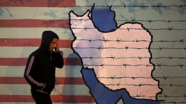 A man walks past an anti-U.S. mural, painted on the wall of the former U.S. Embassy, in Tehran, Iran, Saturday, Nov. 2, 2013. - Sputnik भारत