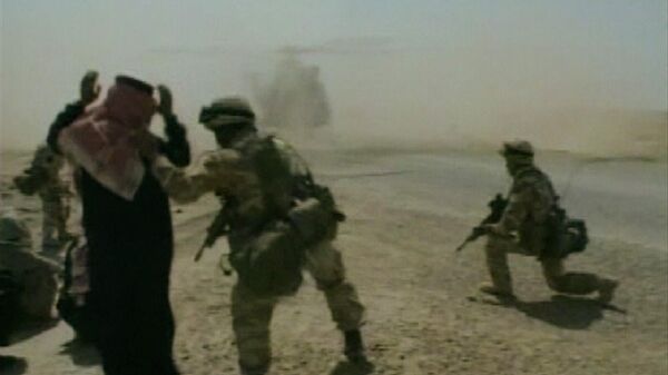 In this image taken from video, a British soldier directs an Iraqi to kneel, while an RAF Puma helicopter lands, Thursday, April 3, 2003, during patrols around Nasiriyah, Iraq.  - Sputnik भारत