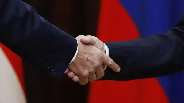 Handshake during a meeting between Russian President Vladimir Putin and US President Donald Trump at the presidential palace in Helsinki. - Sputnik India