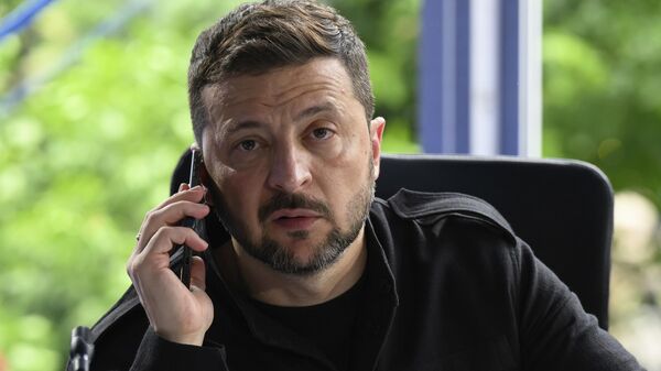Volodymyr Zelensky speaks on the phone during a meeting at the European Political Community summit in Skanderbeg Square in Tirana, Albania, on Friday, May 16, 2025. - Sputnik India