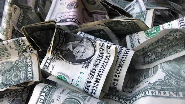 This Wednesday, April 3, 2019, file photo shows a box filled with dollar bills, in New York. - Sputnik भारत