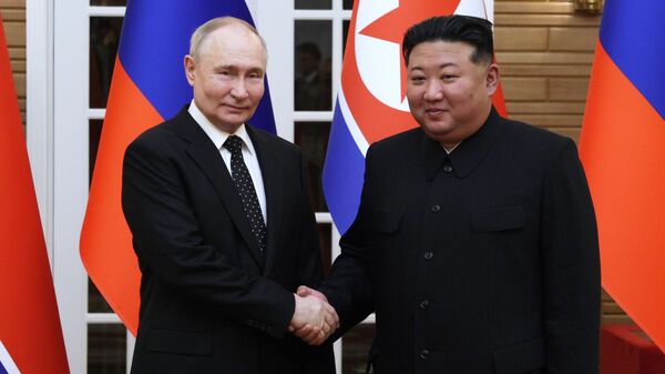 Russian President Vladimir Putin and North Korean leader Kim Jong Un pose for photos after a welcoming ceremony at Kumsusan state residence in Pyongyang, North Korea - Sputnik India