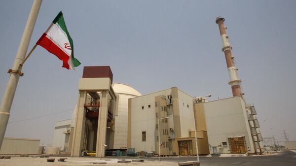 An Iranian flag flutters in front of the reactor building of the Bushehr nuclear power plant, just outside the southern city of Bushehr, Iran, Saturday, Aug. 21, 2010. - Sputnik India