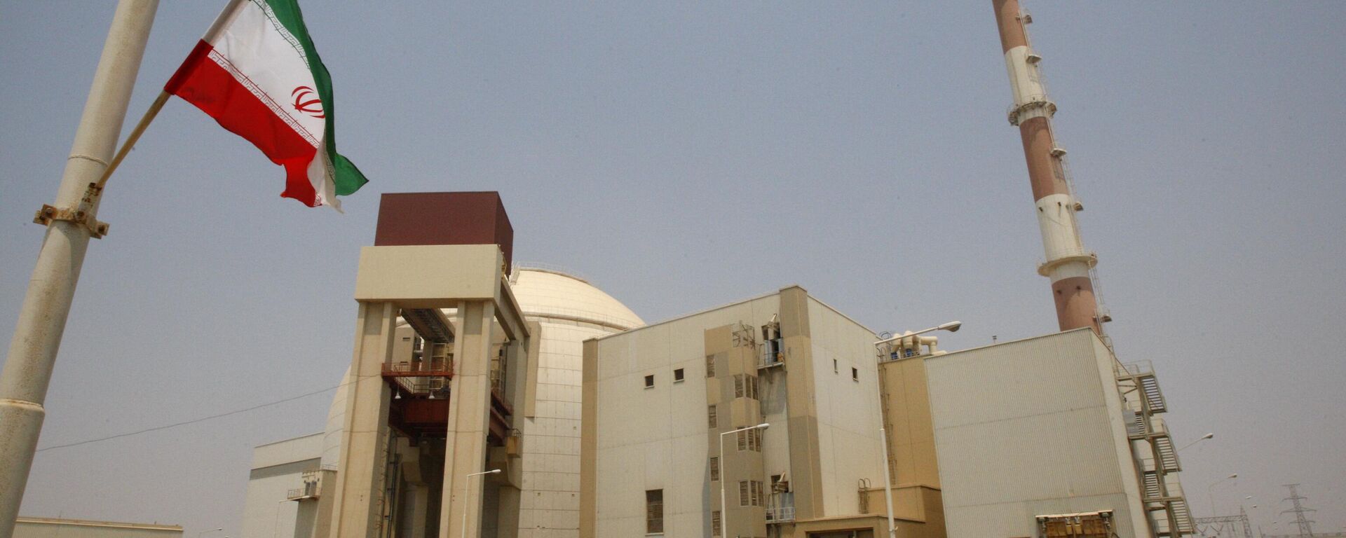 An Iranian flag flutters in front of the reactor building of the Bushehr nuclear power plant, just outside the southern city of Bushehr, Iran, Saturday, Aug. 21, 2010. - Sputnik India, 1920, 12.06.2025