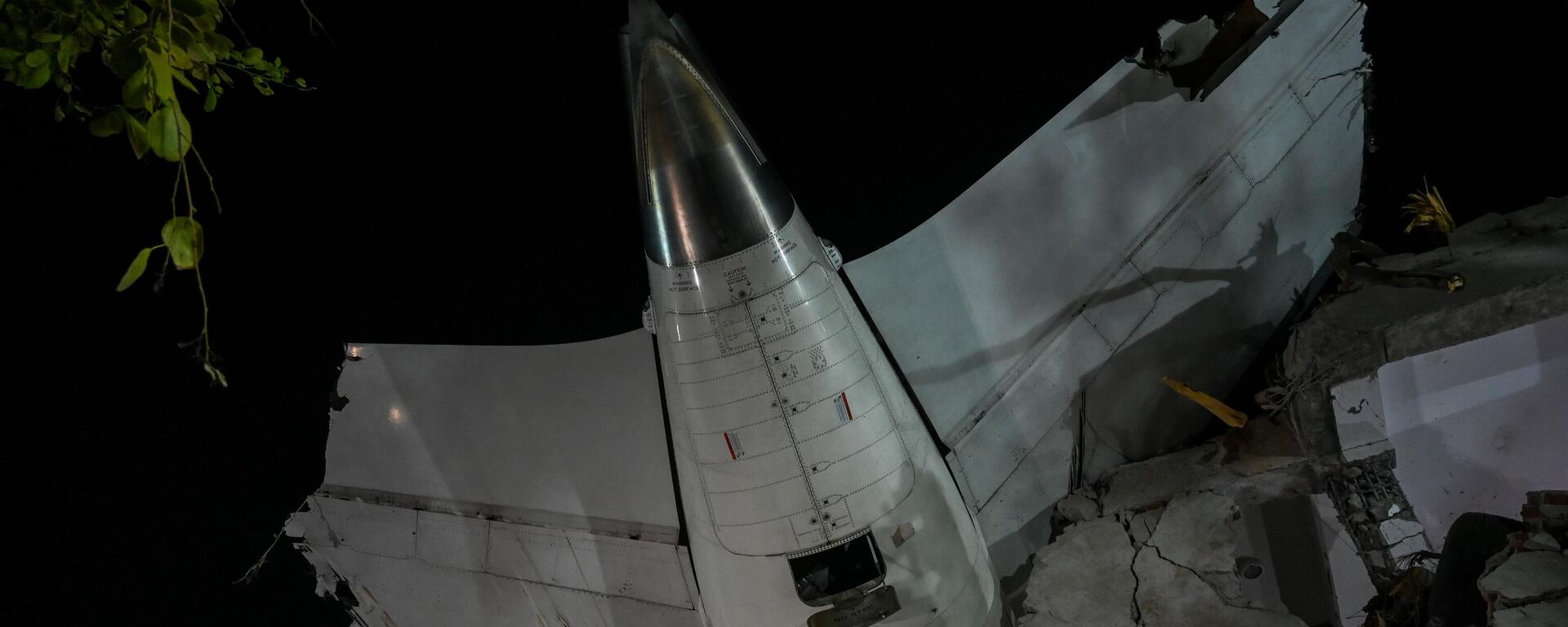 AHMEDABAD, INDIA - JUNE 12: Tail of crashed plane inside hostel building at the site of the Air India flight crash on June 12, 2025 in Ahmedabad, India. 265 people died and many others were injured after the Air India 171 flight headed to London from Ahmedabad crashed moments after take-off. The plane crashed on a resident doctors' hostel in Ahmedabad, which suffered major damage in the accident.  (Photo by Raju Shinde/Hindustan Times via Getty Images) - Sputnik India, 1920, 16.06.2025