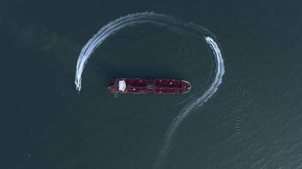 In this Sunday, July 21, 2019 photo, an aerial view shows a speedboat of Iran's Revolutionary Guard moving around the British-flagged oil tanker Stena Impero which was seized in the Strait of Hormuz on Friday by the Guard, in the Iranian port of Bandar Abbas - Sputnik भारत