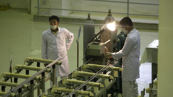 In this April 9, 2009 file picture Iranian technicians work  at a new facility producing uranium fuel for a planned heavy-water nuclear reactor, just outside the city of Isfahan, 255 miles (410 kilometers) south of the capital Tehran. Iran is lagging behind on equipping a bunker with machines enriching uranium to a grade that can be turned quickly to arm nuclear warheads and now says will produce less at the site than originally planned, diplomats tell The Associated Press.   - Sputnik India