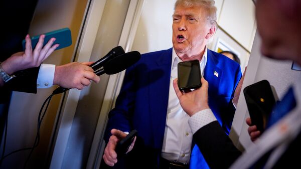 U.S. President Donald Trump speaks to members of the media aboard Air Force One on the way to the 2025 NATO Summit on June 24, 2025 in flight.  - Sputnik भारत
