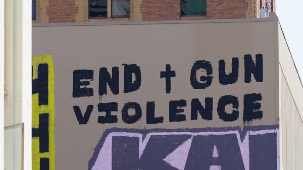 A sign calling for the end of gun violence is displayed, Wednesday, April 6, 2022, on the side of a building near the scene of a recent mass shooting in Sacramento, Calif, Multiple people were killed and injured in the shooting that occurred Sunday, April, 3, 2022. - Sputnik India