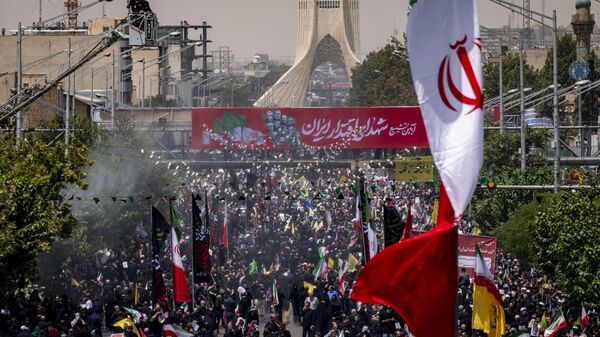 Iranian mourners participate in a funeral for the Islamic Revolutionary Guard Corps (IRGC) commanders, Iranian nuclear scientists, and civilians who are killed in Israeli attacks, in Tehran, Iran, on June 28, 2025, during the Iran-Israel ceasefire. (Photo by Morteza Nikoubazl/NurPhoto via Getty Images) - Sputnik India