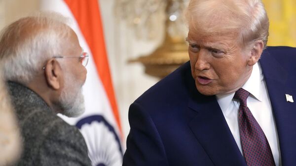 FILE - President Donald Trump, right, speaks with India's Prime Minister Narendra Modi during a news conference in the East Room of the White House, Feb. 13, 2025, in Washington. (AP Photo/Ben Curtis, File) - Sputnik India